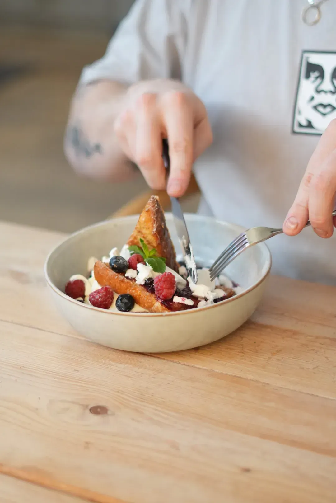 French toast plated with seasonal fruit, served at Blend